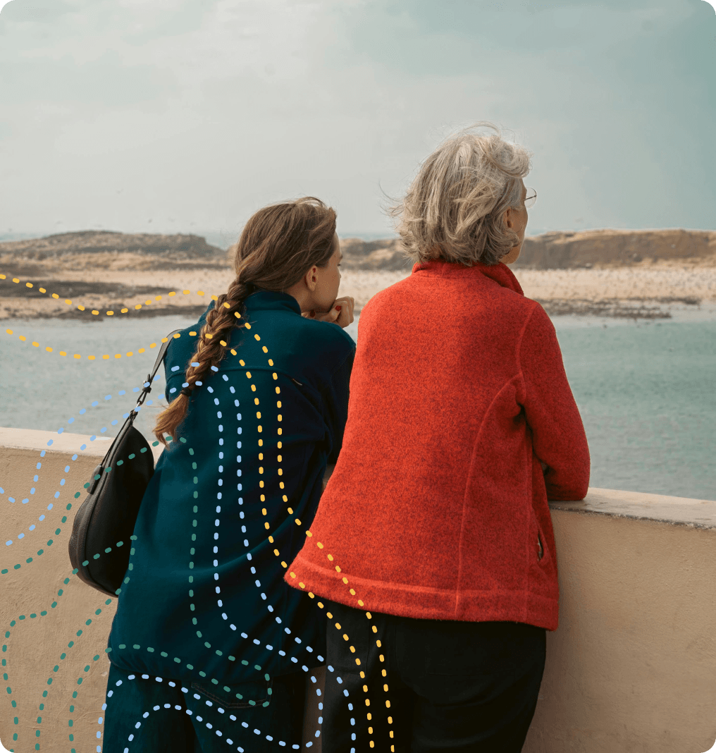Photo of two women staring out to a body of water